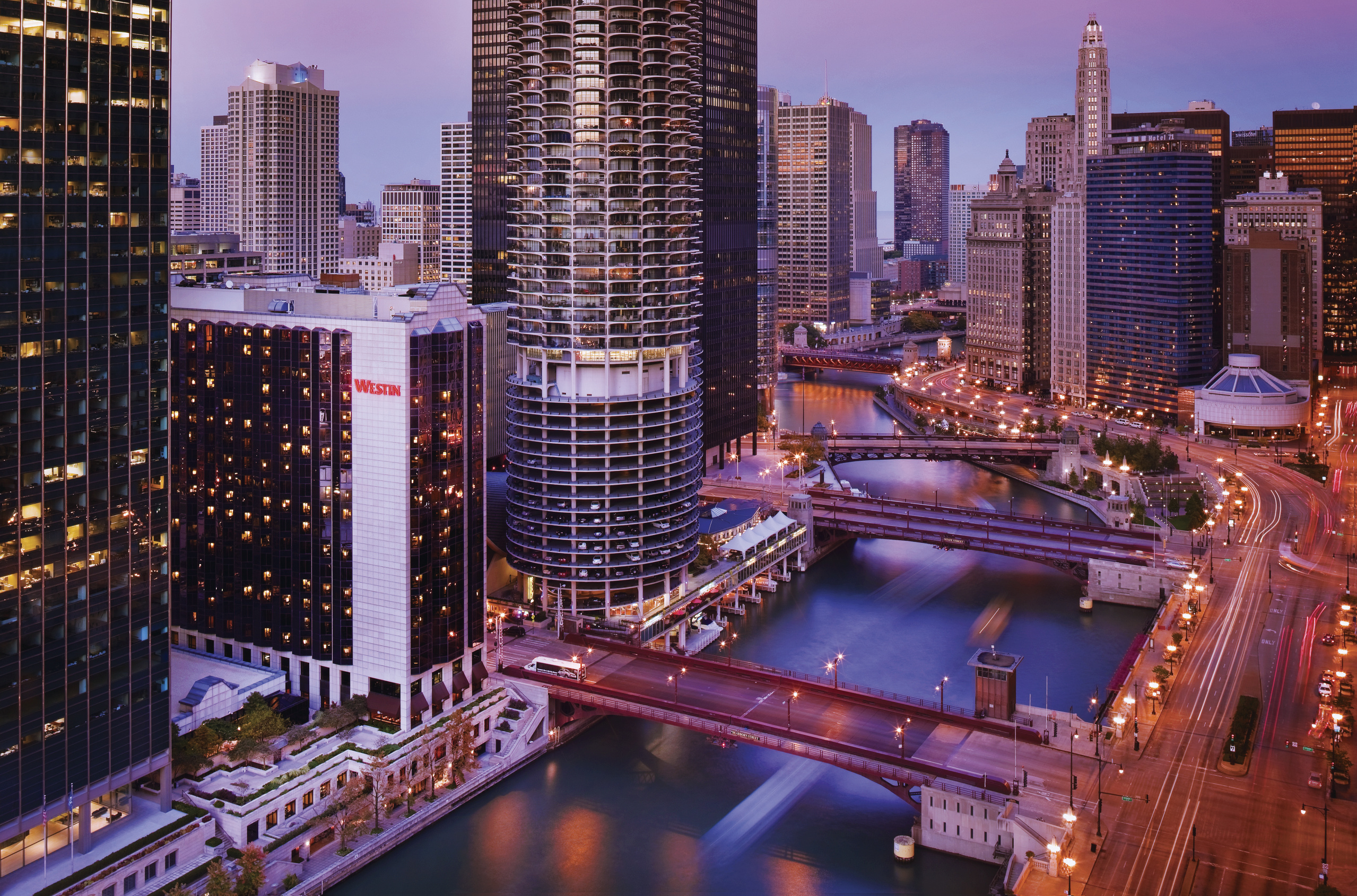 Aerial of buildings and river at dusk